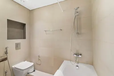 a bathroom with a shower and a toilet and a sink at Silkhaus modern Boulevard 1BDR near Burj Khalifa in Downtown in Dubai