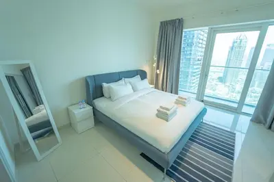 a bedroom with a bed with a large window at AWS Holiday Homes - Unique Views at Damac Heights in Dubai