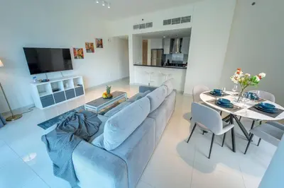 a living room with a couch and a table at AWS Holiday Homes - Unique Views at Damac Heights in Dubai