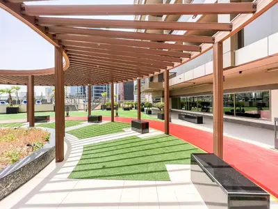 an internal courtyard of a building with benches and grass at Luton Vacation Homes - Elite Downtown Residence Studio, Burj Khalifa View Dubai - 80AB3 in Dubai