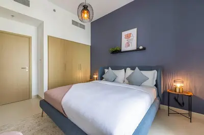 a bedroom with a large bed with purple walls at Daniels 1BR at Creek Horizon with Park View in Dubai
