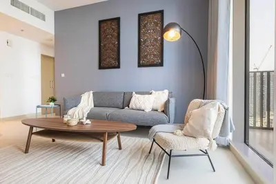 a living room with a couch and a table at Daniels 1BR at Creek Horizon with Park View in Dubai