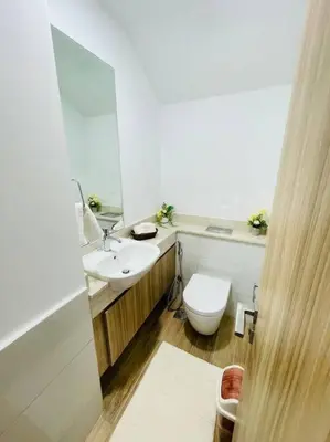 a bathroom with a toilet and a sink and a mirror at Elite Inn: Amaranta75 (Townhouse Direct pool view) in Dubai