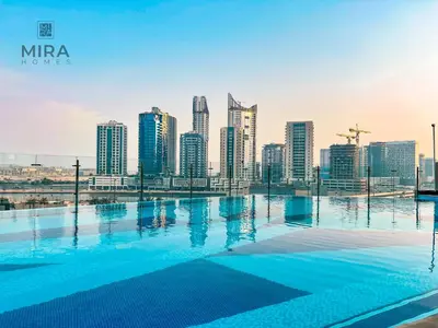 a swimming pool with a city skyline in the background at Mira Holiday Homes - Furnished studio in Downtown in Dubai