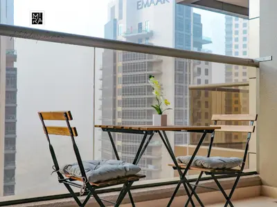 a table and two chairs in front of a window at Mira Holiday Homes - Furnished studio in Downtown in Dubai