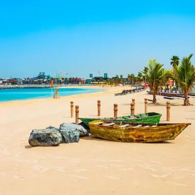 a wooden boat sitting on a sandy beach at Outstanding New Apartment with Sea View In La Mer in Dubai