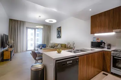 a kitchen and living room with a counter top at Outstanding New Apartment with Sea View In La Mer in Dubai