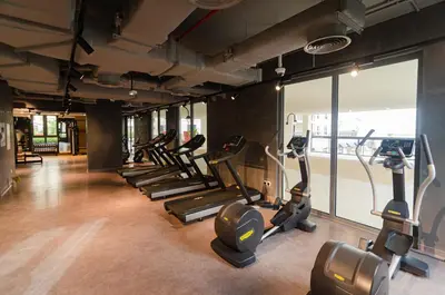 a gym with rows of treadmills and elliptical machines at Outstanding New Apartment with Sea View In La Mer in Dubai