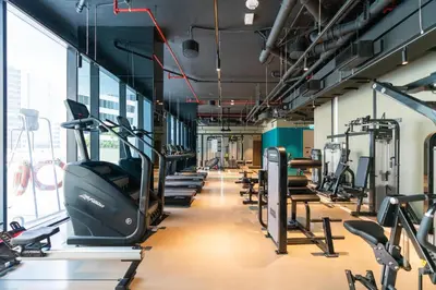 a gym with a row of treadms and cardio machines at Ultimate Stay / 4 Beds / Burj Khalifa View / Ultra Modern / Business Bay in Dubai