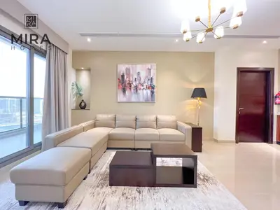 a living room with a couch and a table at Mira Holiday Homes - Lovely 1 bedroom apartment in Downtown in Dubai