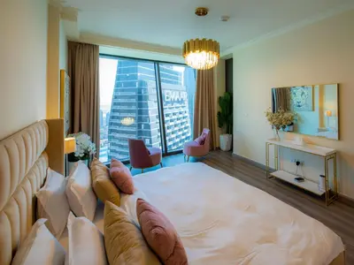 a hotel room with a large bed with a large window at Stylish 3BR Burj Khalifa, Fountain Views, Pool & Prime Location in Dubai
