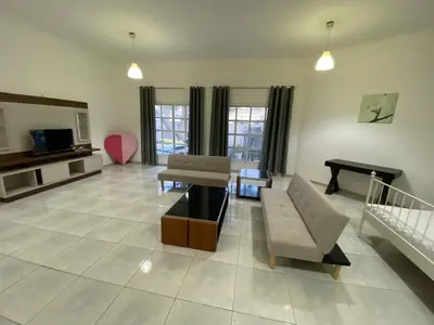 a living room with a couch and a table at Comfortable Private Rooms in Compound Housing in Dubai