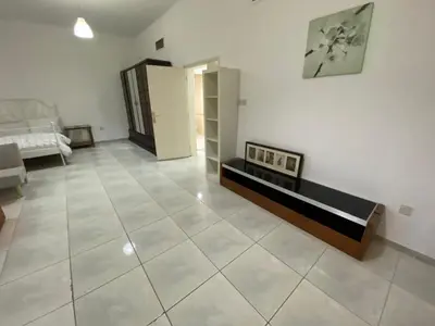 a large living room with a couch and a table at Comfortable Private Rooms in Compound Housing in Dubai