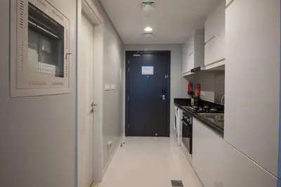 a hallway with a blue door in a kitchen at Premium Studio with Beautiful Golf Course View in Dubai