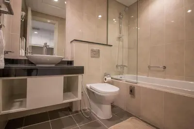 a bathroom with a toilet and a sink and a shower at Premium Studio with Beautiful Golf Course View in Dubai