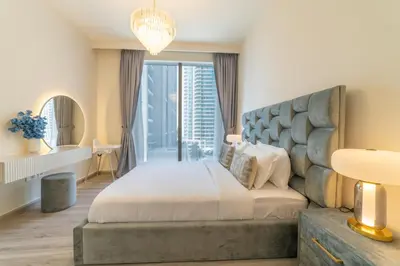 a bedroom with a large bed and a large window at FIRST CLASS 2BR with full DUBAI BOULEVARD view in Dubai