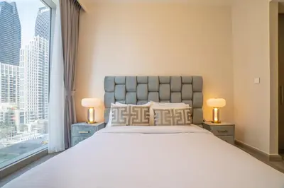 a bedroom with a large bed and a large window at FIRST CLASS 2BR with full DUBAI BOULEVARD view in Dubai