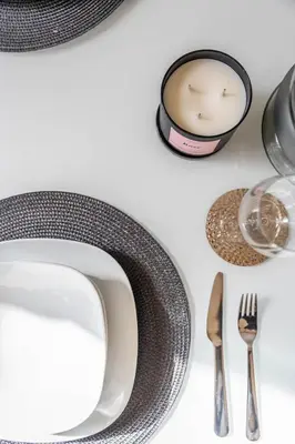 a table with a plate and a candle and a fork and knife at GuestReady - Stunning Apartment in Bluewaters in Dubai