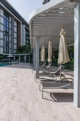 a row of chairs with umbrellas next to a building at GuestReady - Stunning Apartment in Bluewaters in Dubai