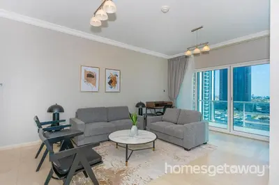 a living room with a couch and a table at HomesGetaway -Fanciful 1BR Apartment in JLT Lake View in Dubai