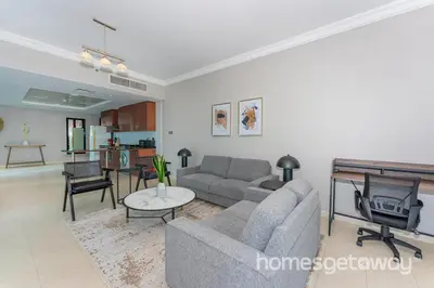 a living room with a couch and a tv at HomesGetaway -Fanciful 1BR Apartment in JLT Lake View in Dubai
