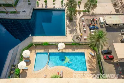 an overhead view of a large swimming pool at HomesGetaway -Fanciful 1BR Apartment in JLT Lake View in Dubai