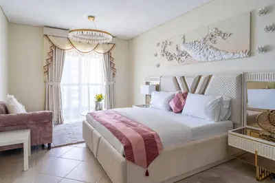 a bedroom with a large bed and a window at Veer Apartments - 82nd Floor Princess Tower - Palm View in Dubai