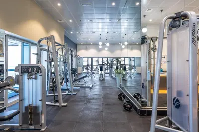 a gym with lots of treadmills and machines at Veer Apartments - 82nd Floor Princess Tower - Palm View in Dubai