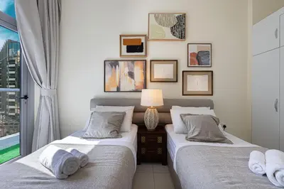 two twin beds in a bedroom with a window at Stylish 3 bedrooms Boho-Style Home in Dubai