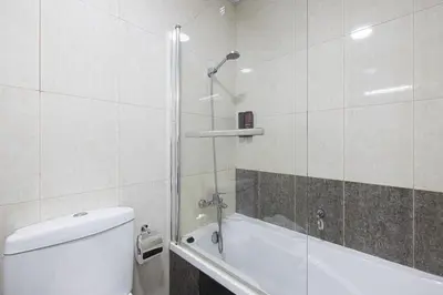 a bathroom with a shower and a toilet and a tub at Stylish 3 bedrooms Boho-Style Home in Dubai