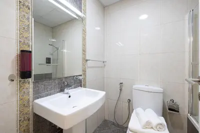 a white bathroom with a sink and a toilet at Stylish 3 bedrooms Boho-Style Home in Dubai