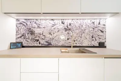 a kitchen with a sink and a painting on the wall at Cayan old in Dubai