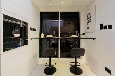 a room with two bar stools in front of a window at Cayan old in Dubai