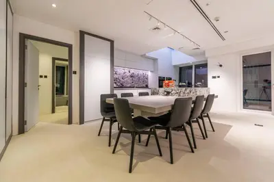 a dining room with a white table and chairs at Cayan old in Dubai