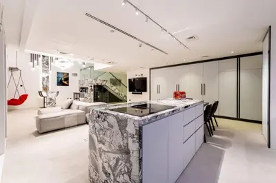 a kitchen with a large island in a living room at Cayan old in Dubai