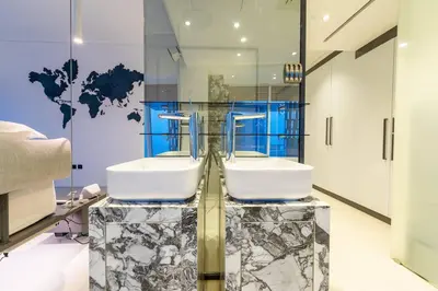 a bathroom with a sink and a glass wall at Cayan old in Dubai
