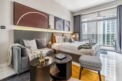 a hotel room with a bed and a couch at GuestReady - Charming Loft 7mins from Burj Khalifa in Dubai