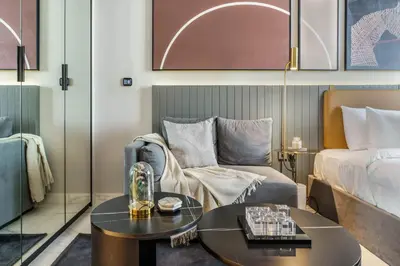 a hotel room with a bed and a coffee table at GuestReady - Charming Loft 7mins from Burj Khalifa in Dubai