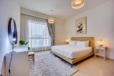 a bedroom with a bed and a large window at 2BD apartment in Bahar JBR near beach in Dubai