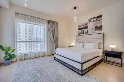 a bedroom with a bed and a large window at 2BD apartment in Bahar JBR near beach in Dubai