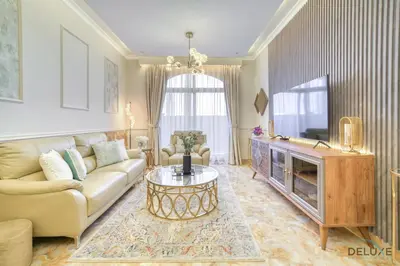 a living room with a couch and a tv at Ornate 2BR at Diamond Views 1, Jumeirah Village Circle by Deluxe Holiday Homes in Dubai