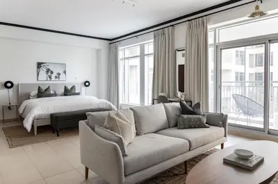 a living room with a couch and a bed at Studio in Burj Views by Radiance Vacation Stays in Dubai