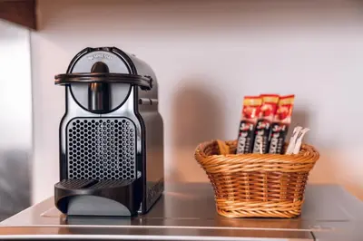 a coffee maker sitting on a counter next to a basket at Elite Royal Apartment - Full Burj Khalifa & Fountain View - Magnum in Dubai