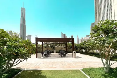 a pavilion with tables and chairs in a city at Elite Royal Apartment - Panoramic Full Burj Khalifa, Fountain & Skyline View - ACed direct connection to Dubai Mall - Governor in Dubai