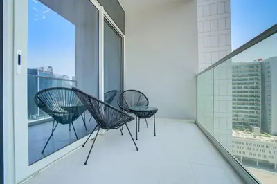 three chairs on a balcony with a view of a city at Classic Arabian Elegance with City Views in Dubai