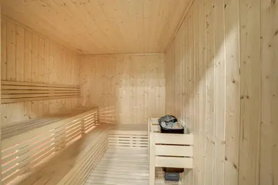 a wooden sauna with a wooden bench in it at Classic Arabian Elegance with City Views in Dubai