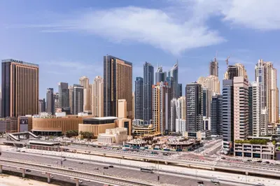 a large city with a highway in the foreground at 180° Sheik Zayed Road balcony views 2BR in JLT in Dubai