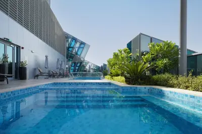 a swimming pool on the side of a building at Lusso Hometels J One Business Bay in Dubai