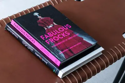 two books sitting on top of a table at 1-bedroom apartment with pool in Dubai