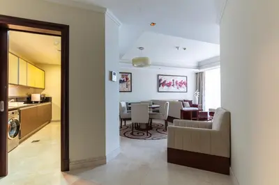 a living room with a kitchen and a dining room at 1-bedroom apartment with pool in Dubai